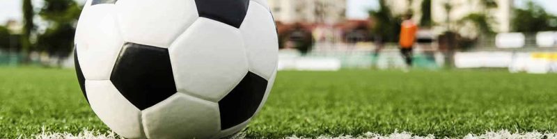 Image of Soccer ball on the green grass of Soccer field.
